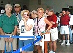 Cruise ship passengers in line inside the Belize Tourist Village to board the small boats that will take them on a tour to the cayes and back to the cruise ship.